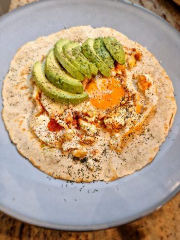Delicious Feta Fried Egg on a Low Carb Tortilla with Pesto and Avocado Slices